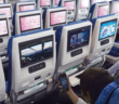 a passenger watching a seatback entertainment screen in an ana boeing 777 cabin