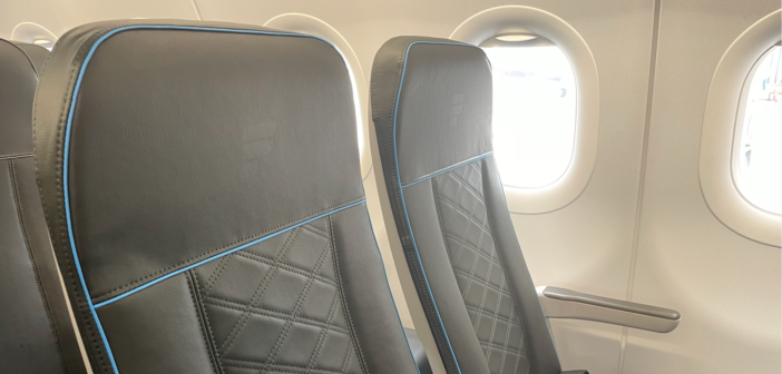 a frontier economy class seat with a padded finish