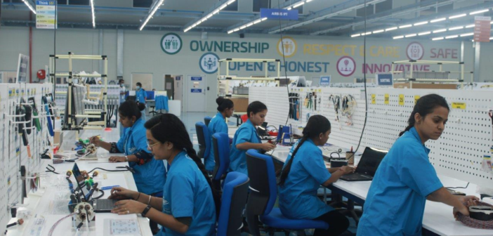 workers assembling wiring systems in the pune india factory