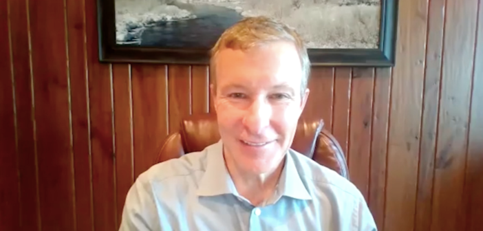 Scott Kirby, CEO of United Airlines, speaking on the wbinar from his wood-lined home office