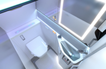 photo of the collins lavatory for the boeing 737. Top view showing an illuminated mirror and grab handles