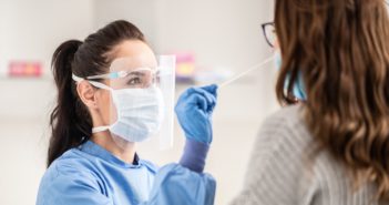 a female being given a Covid-19 swab test by a female doctor
