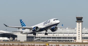 a jetblue airbus a220 taking off from an airport