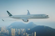 A Cathay Pacific jet flying over Hong Kong harbour