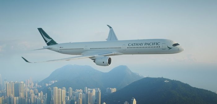 A Cathay Pacific jet flying over Hong Kong harbour
