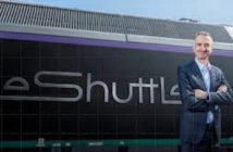 Yann Leriche, CEO of Getlink, parent company of Eurotunnel, next to a train with the the Eurotunnel LeShuttle rebranding