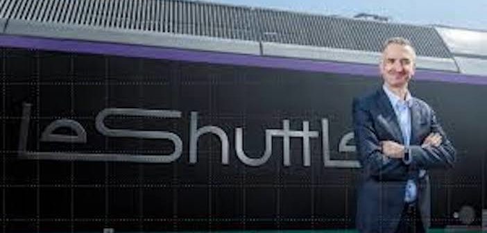 Yann Leriche, CEO of Getlink, parent company of Eurotunnel, next to a train with the the Eurotunnel LeShuttle rebranding