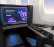 A large Panasonic Astrova IFE screen in a business class aircraft seat