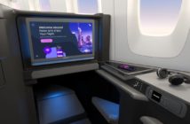 A large Panasonic Astrova IFE screen in a business class aircraft seat