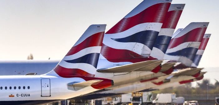 Tail fins of British Airways jets lined up at London Heathrow Airport