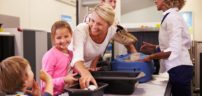 Family At Airport Passing Through Security Check