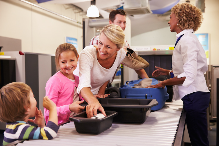 Family At Airport Passing Through Security Check