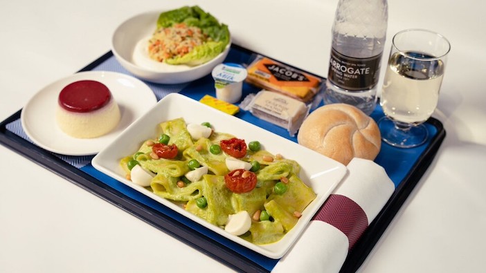 A BA premium economy meal tray with Calamarata pasta and raspberry panna cotta
