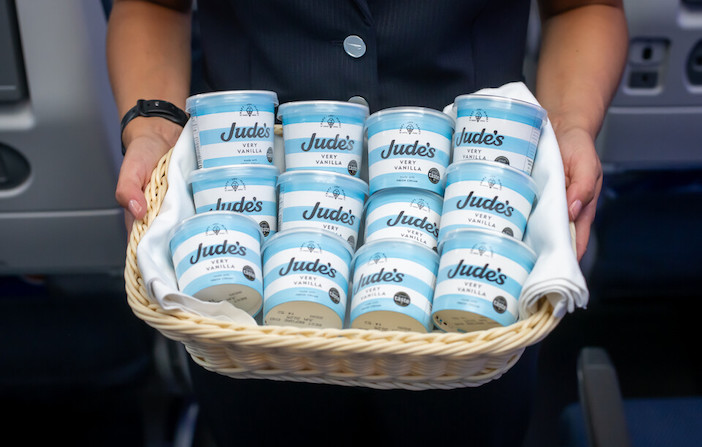 A basket of Jude's ice cream tubs being offered to passengers
