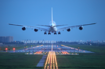 A four-engined airplane taking off at dusk