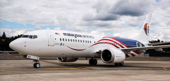 A Malaysia Airlines Boeing 737-8 sitting on a runway