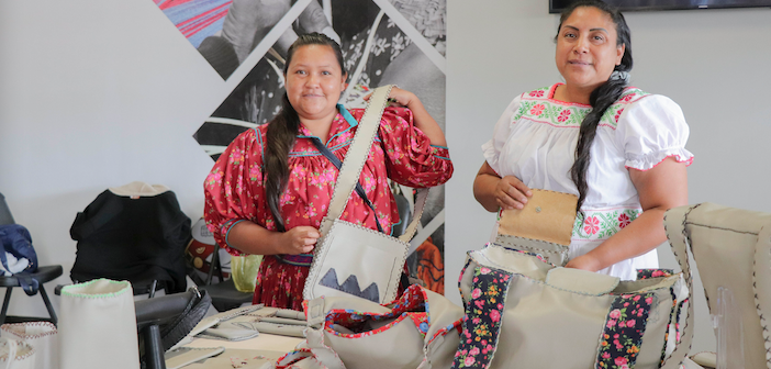 2 women from the the Tarahumara tribe showing their bags in the shop