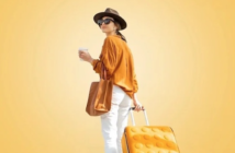 a lady in a yellow and white outfit, with a matching suitcase